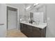 Bathroom with a double sink vanity, a large mirror, and modern lighting at 2815 W 52Nd Ave, Denver, CO 80221