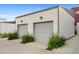 Detached two-car garage with fresh gray doors and well-maintained landscaping at 2815 W 52Nd Ave, Denver, CO 80221