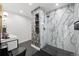Modern bathroom with glass enclosed shower, unique tile and updated fixtures at 2062 Hyacinth Rd, Highlands Ranch, CO 80129