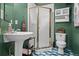 Unique bathroom design with pedestal sink, retro-style radio, and glass stall shower at 2062 Hyacinth Rd, Highlands Ranch, CO 80129