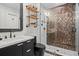 Modern bathroom with sleek vanity, open shelving, and stand-up shower with bronze-colored tiles at 2062 Hyacinth Rd, Highlands Ranch, CO 80129