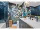 Stylish bathroom with stunning tropical leaf wallpaper and blue accent tiles in shower at 2062 Hyacinth Rd, Highlands Ranch, CO 80129