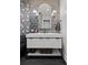 Stylish powder room features designer wallpaper, unique tiling, modern lighting and fixtures at 2062 Hyacinth Rd, Highlands Ranch, CO 80129