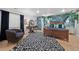 Cozy main bedroom featuring a decorative rug, lounge chair, and dark wooden bed frame at 2062 Hyacinth Rd, Highlands Ranch, CO 80129