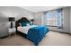 Comfortable bedroom with a king-sized bed, neutral carpet, and floral curtains at 2062 Hyacinth Rd, Highlands Ranch, CO 80129