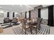 Finished basement with a dining area and seating, featuring a black and white rug at 2062 Hyacinth Rd, Highlands Ranch, CO 80129