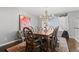 Formal dining room with chandelier lighting, a large wooden table and seating for eight, perfect for entertaining at 2062 Hyacinth Rd, Highlands Ranch, CO 80129
