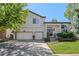 Charming two-story home with landscaped front yard, a two car garage, and a welcoming front porch at 2062 Hyacinth Rd, Highlands Ranch, CO 80129