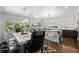 Bright kitchen featuring a spacious island with bar seating, a dining area, and ample natural light at 2062 Hyacinth Rd, Highlands Ranch, CO 80129