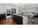 Modern kitchen with large island, sleek appliances, and an open layout at 2062 Hyacinth Rd, Highlands Ranch, CO 80129
