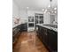 Well-appointed kitchen featuring custom cabinetry, modern appliances, and access to the staircase at 2062 Hyacinth Rd, Highlands Ranch, CO 80129