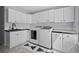 Bright laundry room featuring sleek appliances, ample cabinet space, and stylish floors at 2062 Hyacinth Rd, Highlands Ranch, CO 80129