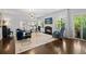 Bright living room with a fireplace, large windows, and hardwood floors, offering a cozy and inviting atmosphere at 2062 Hyacinth Rd, Highlands Ranch, CO 80129