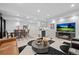 Spacious living room featuring plush seating, a dining area, and an entertainment center at 2062 Hyacinth Rd, Highlands Ranch, CO 80129