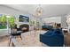 Cozy living room with a fireplace, comfortable seating, and views into the open concept kitchen at 2062 Hyacinth Rd, Highlands Ranch, CO 80129