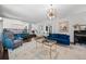 Sunlit living area with modern light fixture and comfortable seating at 2062 Hyacinth Rd, Highlands Ranch, CO 80129