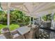 Covered outdoor patio featuring a large dining table and backyard views at 2062 Hyacinth Rd, Highlands Ranch, CO 80129