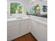 Bright wet bar featuring a sink, white cabinets, a view to outside, and modern design at 2062 Hyacinth Rd, Highlands Ranch, CO 80129