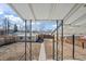 Spacious backyard with a detached garage, wooden fence, and a concrete walkway at 4573 S Acoma St, Englewood, CO 80110
