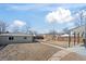 Large backyard with a detached garage and wooden fence, offering privacy and space for outdoor activities at 4573 S Acoma St, Englewood, CO 80110