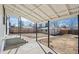 Covered patio overlooking the spacious backyard and detached garage, perfect for relaxation and entertaining at 4573 S Acoma St, Englewood, CO 80110