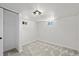Unfinished basement with carpet and two small windows at 4573 S Acoma St, Englewood, CO 80110
