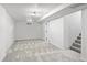 Basement featuring modern gray carpeting and staircase, perfect for a cozy recreational area at 4573 S Acoma St, Englewood, CO 80110
