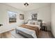 Bedroom with natural light, a queen bed, neutral colors, and hardwood floors at 4573 S Acoma St, Englewood, CO 80110