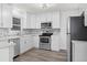 Clean kitchen featuring white cabinets, stainless steel appliances, and natural light at 4573 S Acoma St, Englewood, CO 80110