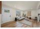 Bright living room with hardwood floors, white sofa, neutral rug, and modern decor at 4573 S Acoma St, Englewood, CO 80110