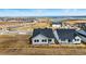Aerial view of a home in a new development featuring a beautiful lake view at 17196 W 92Nd Loop, Arvada, CO 80007