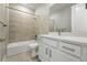 Bright bathroom featuring a shower-over-tub with neutral tile and a vanity with white countertop at 17196 W 92Nd Loop, Arvada, CO 80007