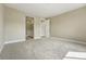 Spacious bedroom with neutral tones, plush carpet, and an en-suite bathroom for added convenience at 17196 W 92Nd Loop, Arvada, CO 80007