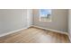 Cozy bedroom features wood-look flooring, a window with a view, and a neutral color palette at 17196 W 92Nd Loop, Arvada, CO 80007