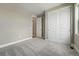 Neutral bedroom with light gray walls, carpet, and double-door closet at 17196 W 92Nd Loop, Arvada, CO 80007