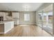 Open concept dining area features sleek floors, modern lighting, and access to an outdoor patio at 17196 W 92Nd Loop, Arvada, CO 80007