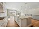 Bright, open kitchen with a large island, stainless steel sink, and an expansive view through sliding glass doors at 17196 W 92Nd Loop, Arvada, CO 80007