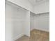 Walk-in closet featuring carpeted floor and shelving at 17196 W 92Nd Loop, Arvada, CO 80007