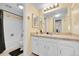 Well-lit bathroom featuring a vanity with marble countertop, a large mirror, and a tub/shower combo at 4066 S Atchison Way # 102, Aurora, CO 80014
