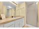 Bright bathroom with a large mirror, ample cabinet space, and a glass-enclosed shower at 4066 S Atchison Way # 102, Aurora, CO 80014
