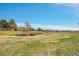 Scenic view of community green space with walking path and pond, complemented by mature trees at 4066 S Atchison Way # 102, Aurora, CO 80014