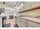 Open kitchen featuring light countertops and cabinets seamlessly connecting with the dining area at 4066 S Atchison Way # 102, Aurora, CO 80014