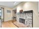 Living room view with stone fireplace and hardwood floors at 4066 S Atchison Way # 102, Aurora, CO 80014