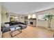 Open living room with stone fireplace and hardwood floors at 4066 S Atchison Way # 102, Aurora, CO 80014