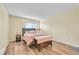 Cozy main bedroom with a double bed, wooden floors, and a warm ambiance at 4066 S Atchison Way # 102, Aurora, CO 80014