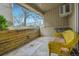 Cozy covered patio featuring a wicker chair with cushions and a pleasant outdoor view at 4066 S Atchison Way # 102, Aurora, CO 80014
