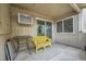 Relaxing covered patio area with wicker seating, a table, and natural light at 4066 S Atchison Way # 102, Aurora, CO 80014
