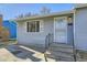 Front entrance with stairs and security door at 4855 Dover St, Arvada, CO 80002