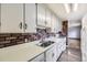 Kitchen with white cabinets and brick backsplash at 4855 Dover St, Arvada, CO 80002