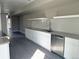 Bright kitchen with white cabinets, a stainless steel dishwasher, and open shelving at 1642 N Lafayette St # 2, Denver, CO 80218